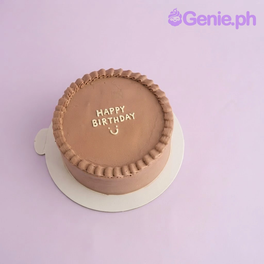 Brown Minimalist Birthday Cake Brown 1-tier cake with smooth soft icing, piped shell border, and white piped Happy Birthday message