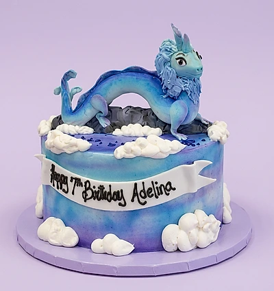 Blue and purple 1-tier birthday cake with a 3D blue dragon topper and white fondant clouds