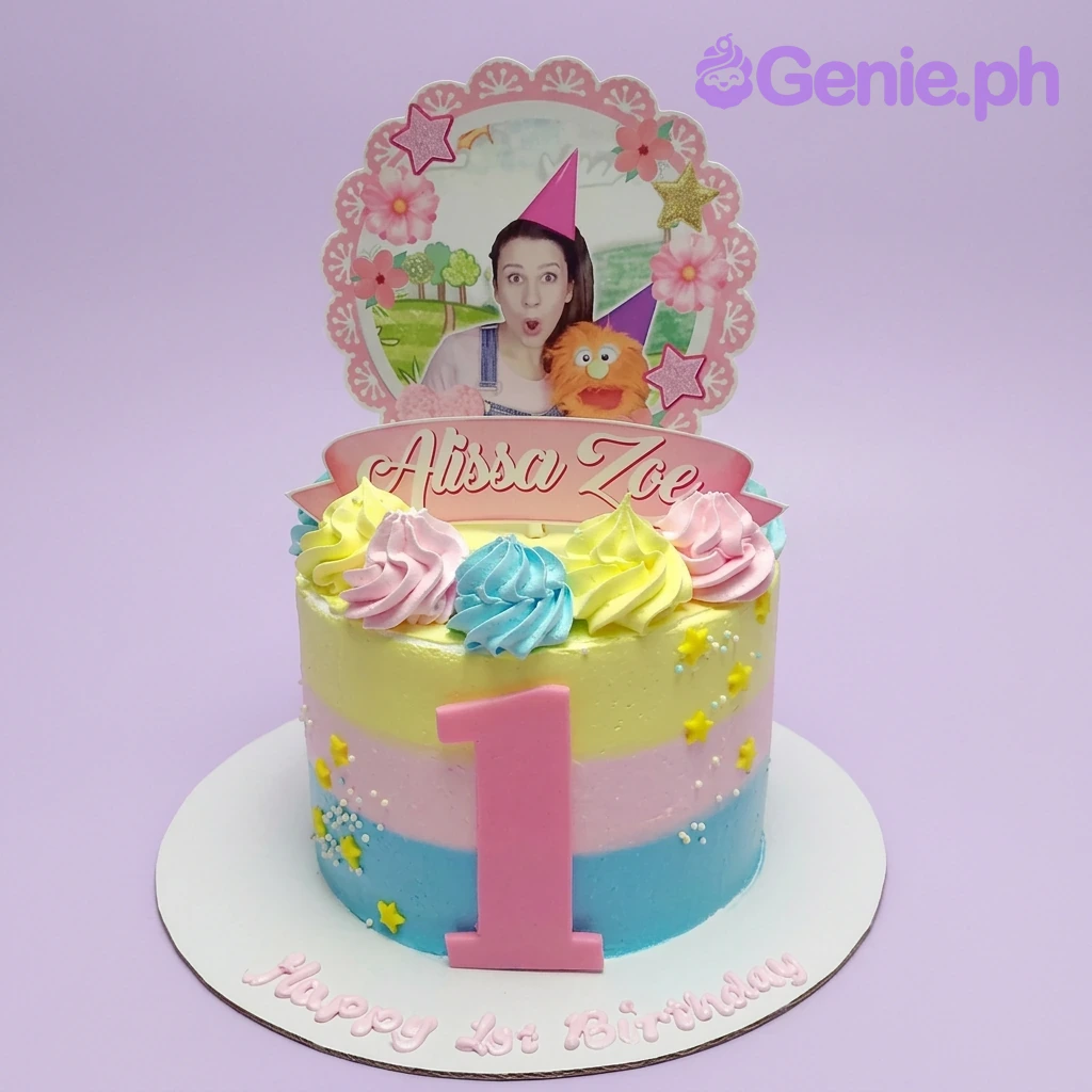 1st Birthday Photo Floral Cake A colorful 1 Tier 1st Birthday Photo cake featuring a custom photo, name banner, number 1, stripes, and icing swirls.