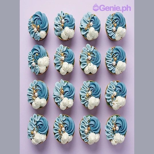 Blue Floral Cupcakes A box of twelve cupcakes with light blue icing swirls, white piped rosettes, and gold pearl accents