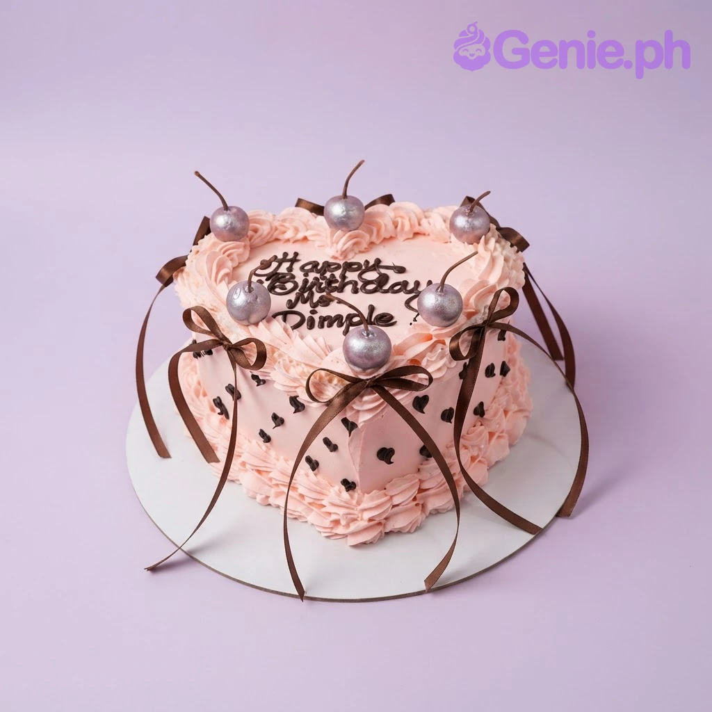 Cherry Heart Pink Birthday Cake Pink heart-shaped 1-tier cake with soft icing, piped shell borders, silver cherry toppers, and brown ribbon bows