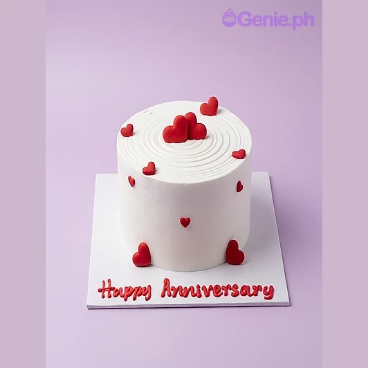 Anniversary Heart White Cake White 1-tier anniversary cake with red heart decorations and piped Happy Anniversary message on the board