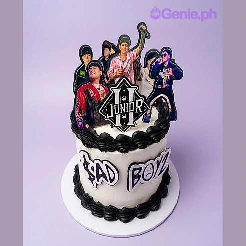 Bad Boys White Cake One tier white soft-iced cake with a Junior logo printout, four band member printouts, black piped borders, and a piped message