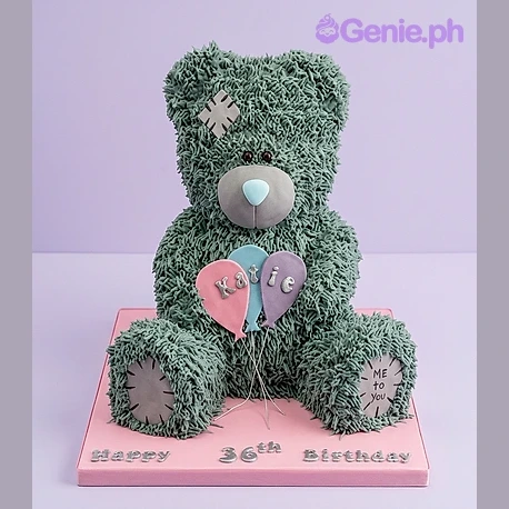 Bear Silver Birthday Cake Grey bear-shaped cake with piped fur texture, holding three pastel balloons, with a name on the side and a birthday message on the board