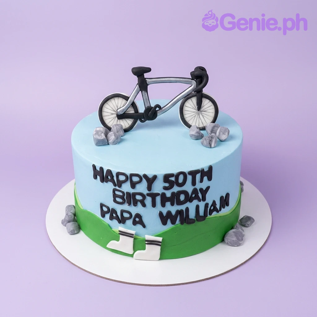 Bicycle Birthday Sky Blue Cake A light blue 1 Tier cake themed for a 50th Bicycle Birthday, with a black bicycle topper, fondant rocks, and green grass icing.