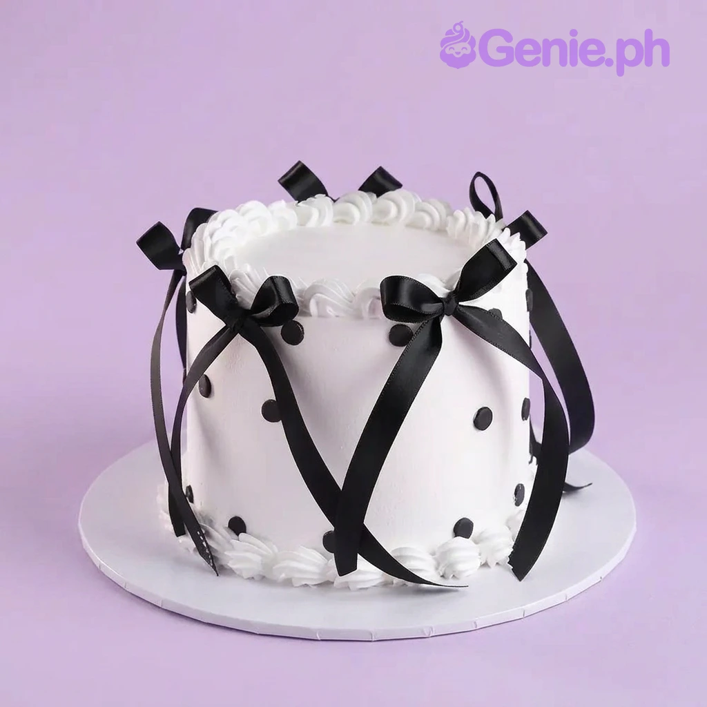 Black White Ribbon Cake White 1-tier cake with smooth soft icing, black satin ribbon bows, and black polka dot accents