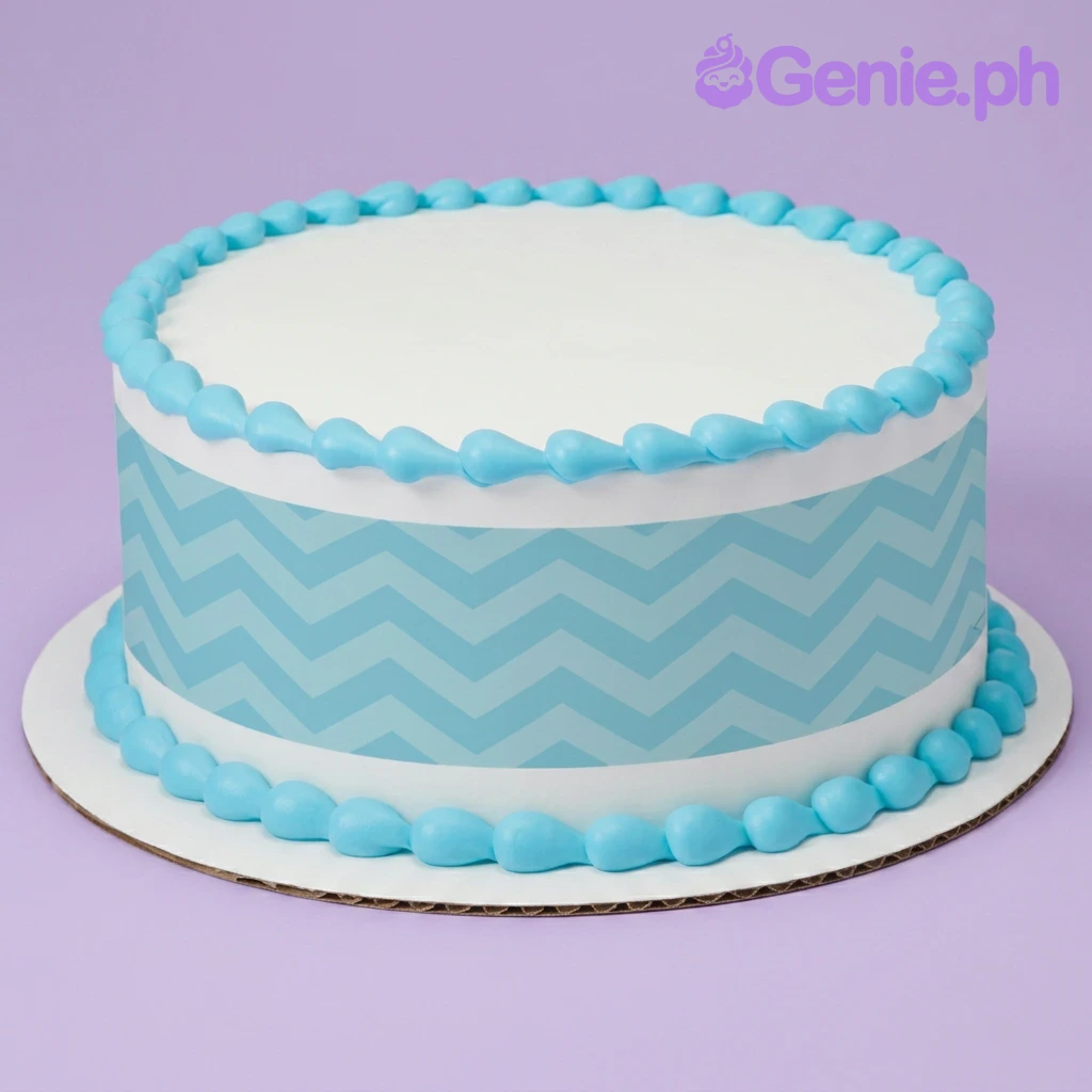 Blue Chevron White Cake A white round cake with a blue chevron pattern side wrap, and blue icing teardrop borders on the top and base.