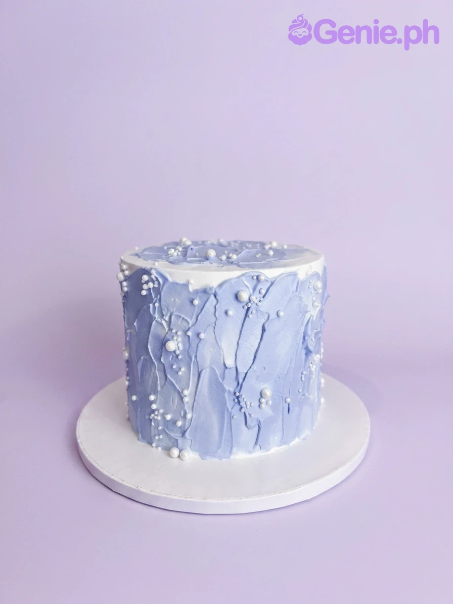Blue Palette Knife Pearl Cake A white and light blue 1 Tier cake with textured light blue palette knife icing and white pearl sprinkles.