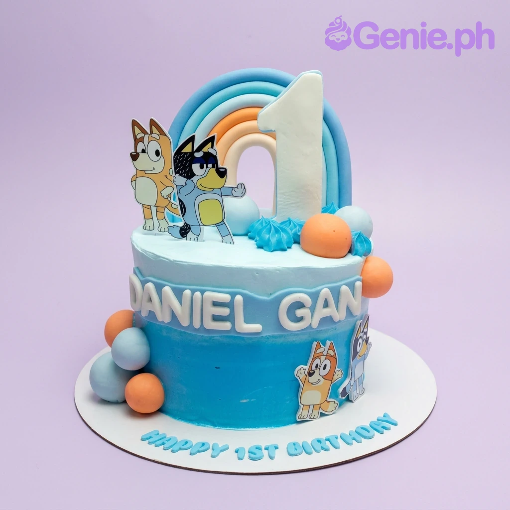 A blue gradient 1-Tier Bluey cake featuring character printouts, a number one, and a rainbow. A blue gradient 1-Tier Bluey cake featuring character printouts, a number one, and a rainbow.
