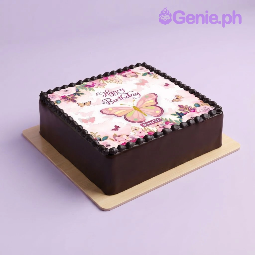 Brown square cake with edible photo print of butterfly and flowers on top and black piped border