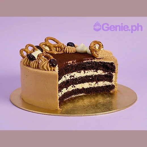 Chocolate cake with coffee chiffon sponge and mascarpone chantilly cream topped with pretzels and coffee beans