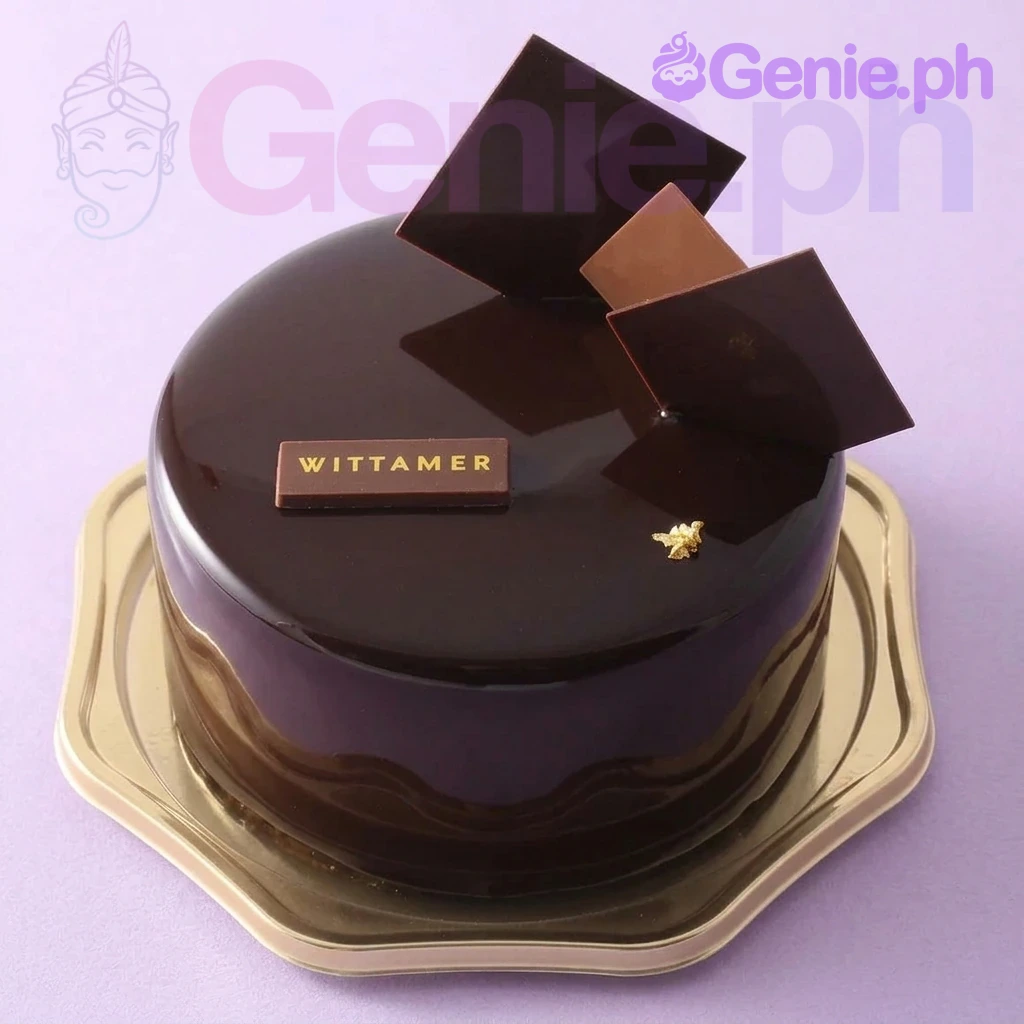 Chocolate Mirror Glaze Brown Cake A dark brown 1 Tier cake themed around Chocolate Mirror Glaze, featuring geometric chocolate squares and a gold Wittamer logo plaque.