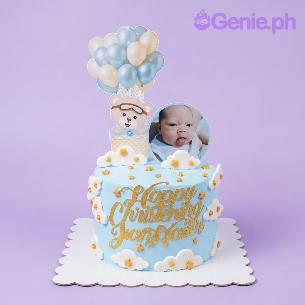 Christening Bear Sky Blue Glitter Cake A light blue 1-tier Christening Bear cake, featuring a bear in a hot air balloon, a baby photo, and a gold message.