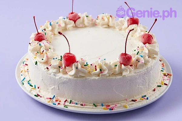 Classic Cherry White Birthday Cake A white 1-tier round cake themed around Classic Cherry, featuring red cherries with stems and whipped icing swirls with rainbow sprinkles.