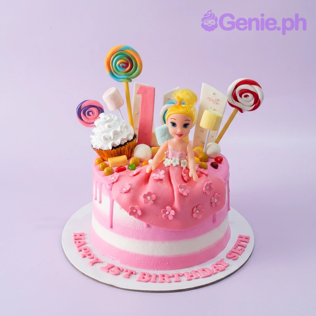 Doll Cake Pink and white striped doll cake with a blonde doll topper, lollipops, marshmallows, and a cupcake decoration.