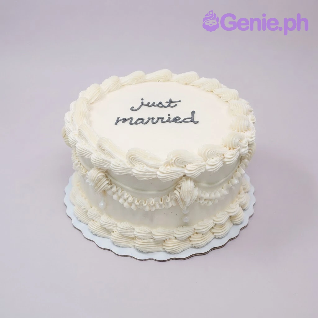 Wedding White Vintage Cake White 1-tier vintage soft icing cake with piped shell borders and black piped just married script