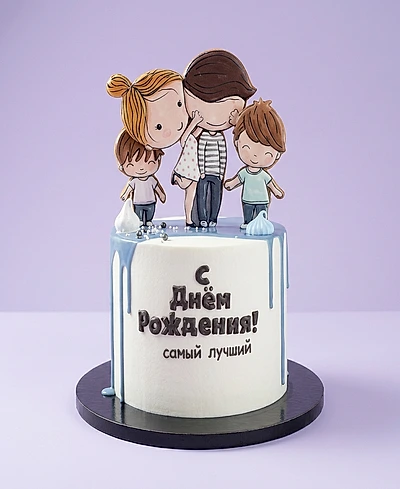White single tier birthday cake with blue drip and a printout of a family of four on top