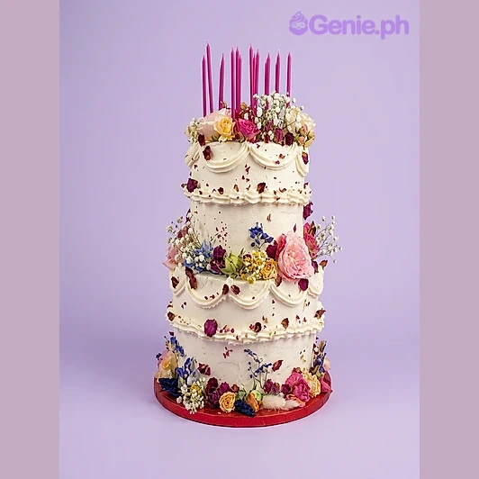 Floral Birthday White 2-Tier Cake White 2-tier birthday cake with pink candles and assorted fresh flowers