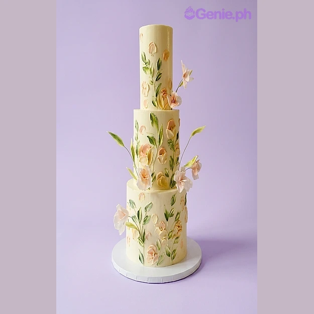 Floral Ivory 3-Tier Cake Ivory 3-tier fondant cake decorated with hand-painted peach and pink floral icing designs