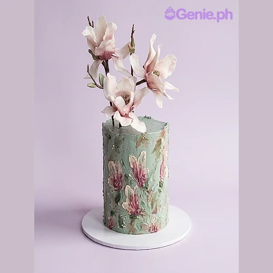 Floral Magnolia Mint Cake Sage green single-tier cake with large edible magnolia flowers on top and painted floral designs on the side