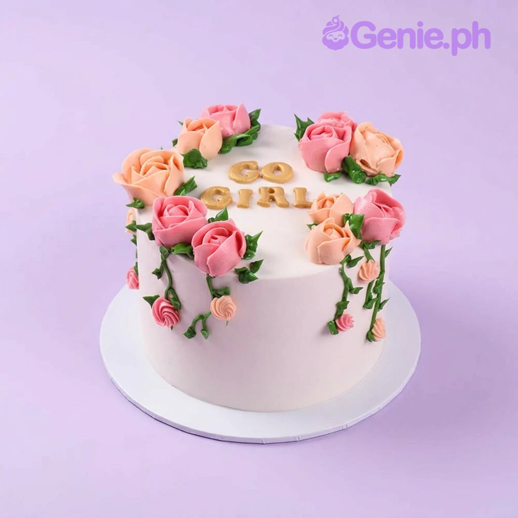 Floral Minimalist Pink Birthday Cake Light pink 1-tier cake with soft icing, gold fondant letters spelling GO GIRL, and piped pink and peach icing roses with green vines