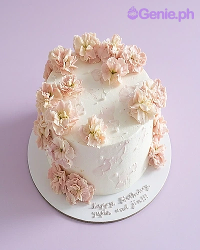 Floral Minimalist White Birthday Cake A white and light pink 1-tier cake themed Floral Minimalist, featuring light pink piped icing flowers, white pearls, and a silver birthday message.