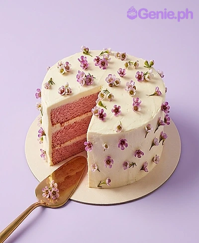 Floral Minimalist White Birthday Cake A white 1 Tier cake themed around Floral Minimalist, adorned with small purple and white edible flowers.