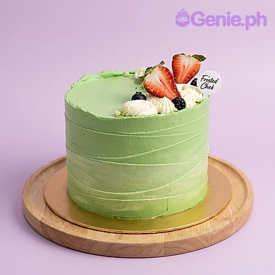 Green Strawberry Mint Birthday Cake Green frosted cake with fresh strawberries and a logo topper
