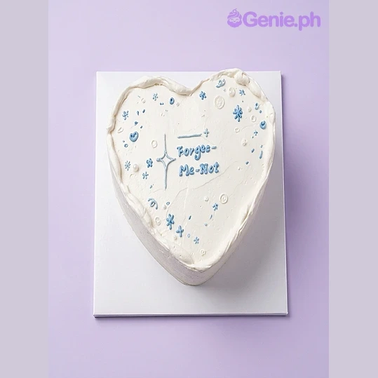Heart Minimalist White Cake White heart-shaped cake with blue piped icing stars and text