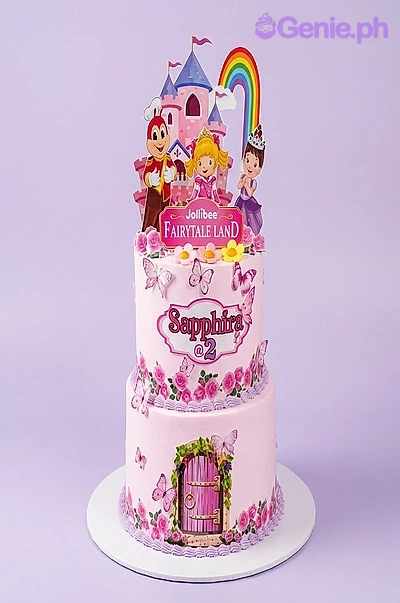 Jollibee Fairytale Land Pink 2-Tier Birthday Cake A pink 2-tier cake themed around Jollibee Fairytale Land, featuring character printouts, a pink castle, and a rainbow.