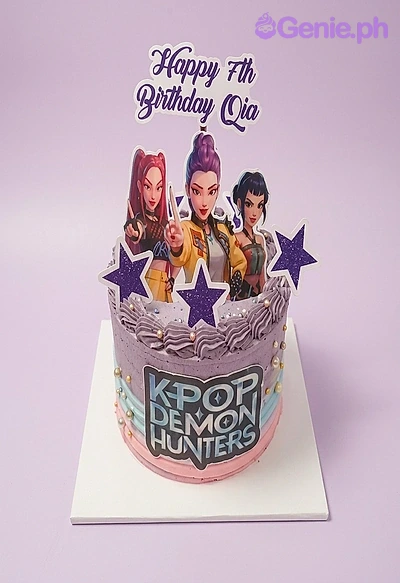 K-Pop Demon Hunters-Inspired Birthday Cake A purple and pink 1-tier cake themed around K-Pop Demon Hunters, featuring character and logo printouts and purple stars.