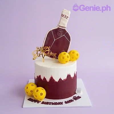 Liquor Birthday Glitter Cake White and dark red single tier cake with a printed liquor bottle topper and yellow ball decorations