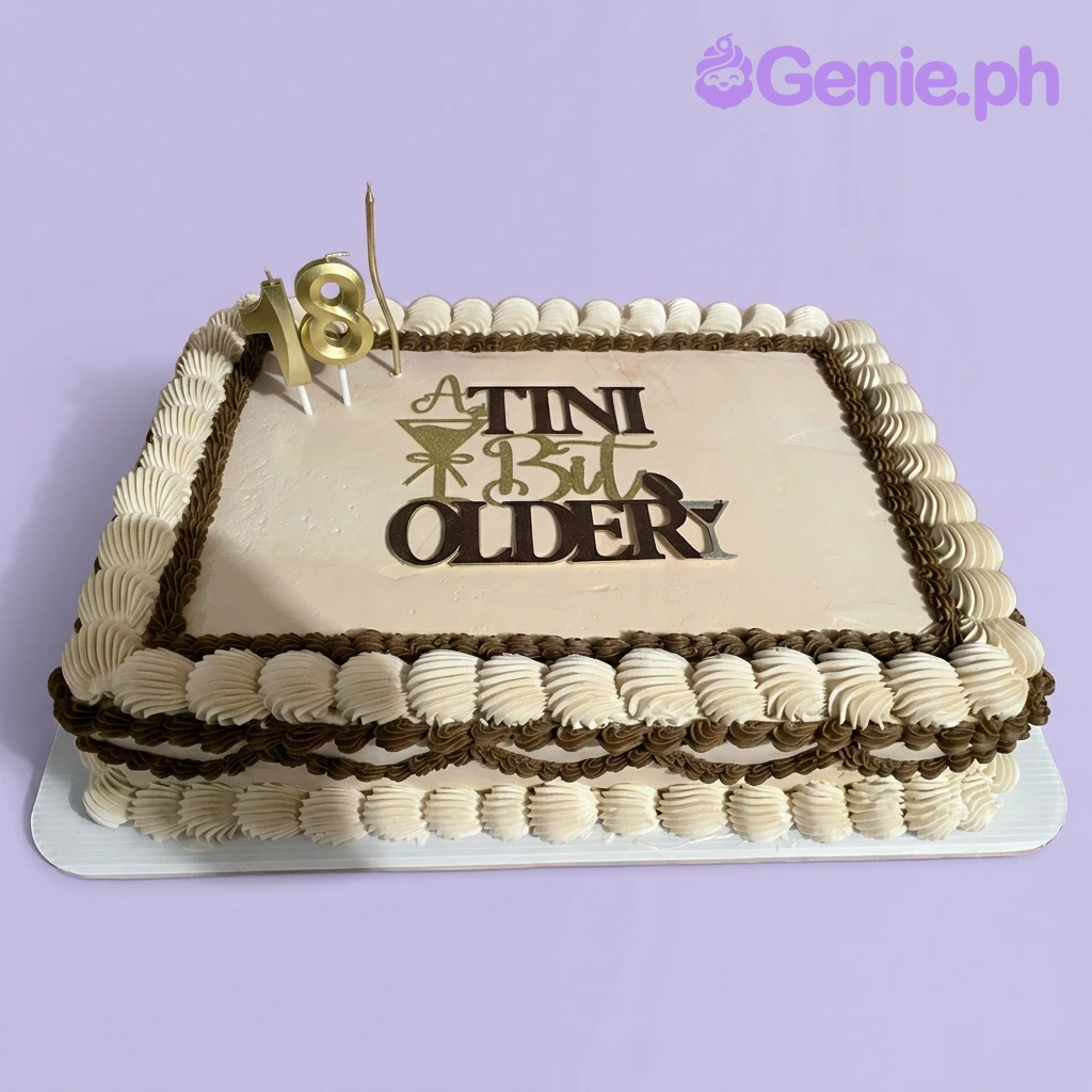 Martini Birthday Ivory Rectangle Cake A beige rectangle Martini cake, featuring a 'Tini Bit Older' martini topper and brown and white piped borders.