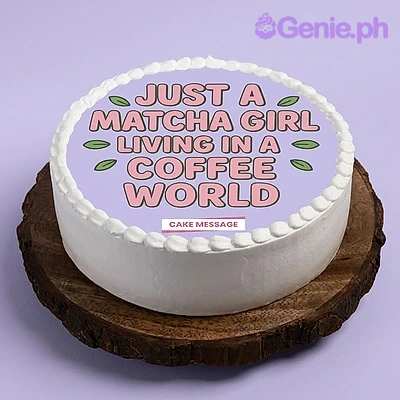 Matcha Girl White Birthday Cake A white 1-tier cake themed around Matcha Girl, featuring a purple and pink printed topper with a coffee quote and white piped icing borders.