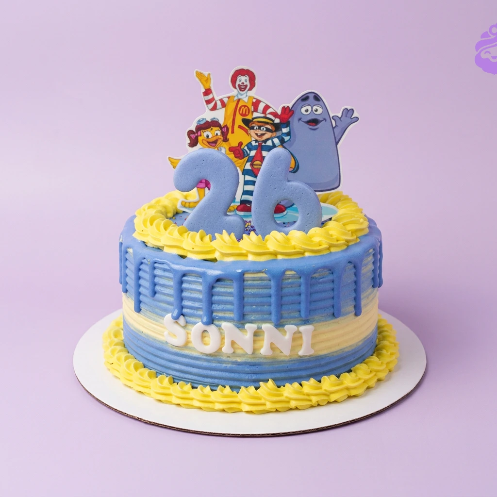 A blue and yellow 1-tier cake themed around McDonald's, featuring Ronald McDonald characters and a large blue number 26 topper.
