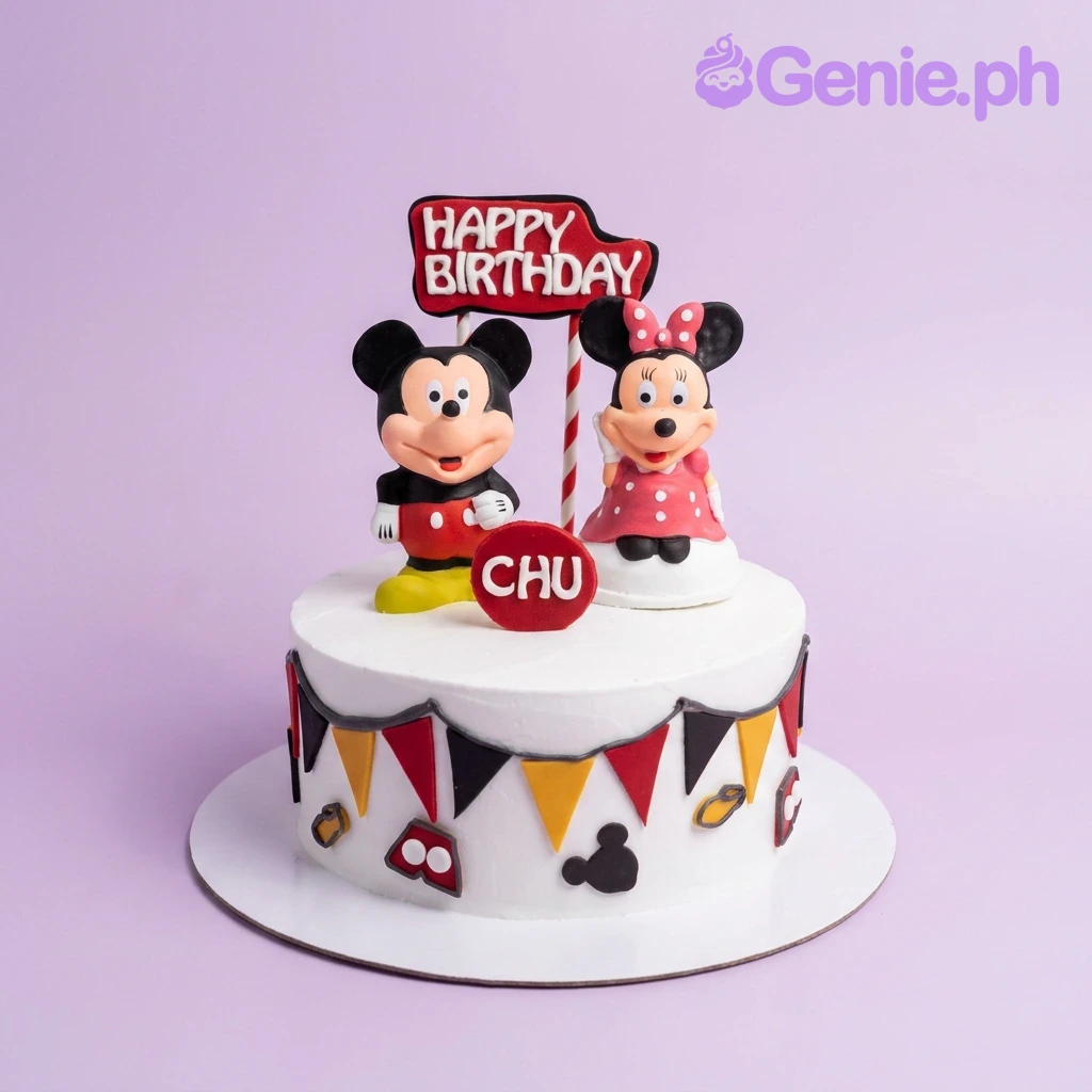 A white 1-tier Mickey Mouse cake, featuring Mickey and Minnie, 'Happy Birthday' sign, red and black bunting. A white 1-tier Mickey Mouse cake, featuring Mickey and Minnie, 'Happy Birthday' sign, red and black bunting.