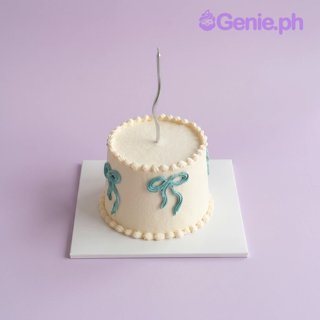 Minimalist Bow White Birthday Cake White 1-tier cake with piped blue bows and a single silver candle