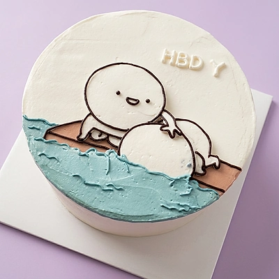White bento cake with a minimalist hand-drawn character and blue icing waves at the bottom.
