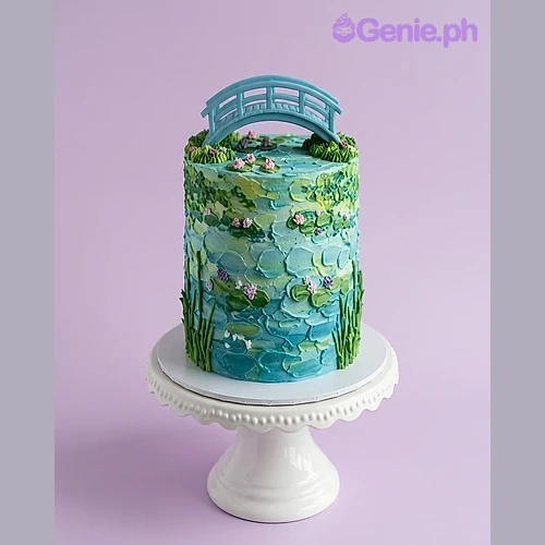 Monet Cake Blue 1-tier cake with impressionist painting style icing, pink water lilies, and a blue bridge topper