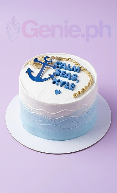 White minimalist nautical cake with blue anchor printout and blue fondant lettering for Kyle.