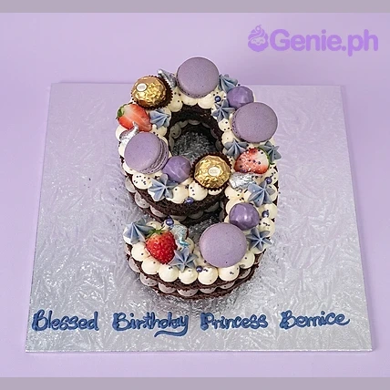 Number Birthday Cake Number 9 shaped birthday cake with purple macarons, gold chocolates, strawberries, and blue piped message