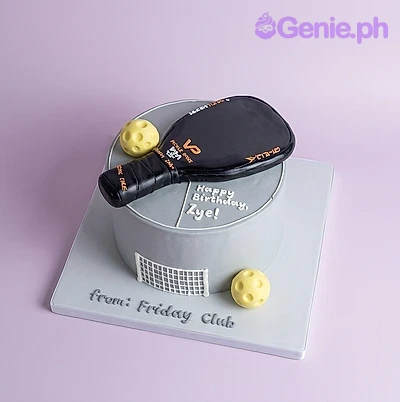Pickleball Silver Birthday Cake Grey single tier pickleball themed cake with a black paddle and yellow balls on top