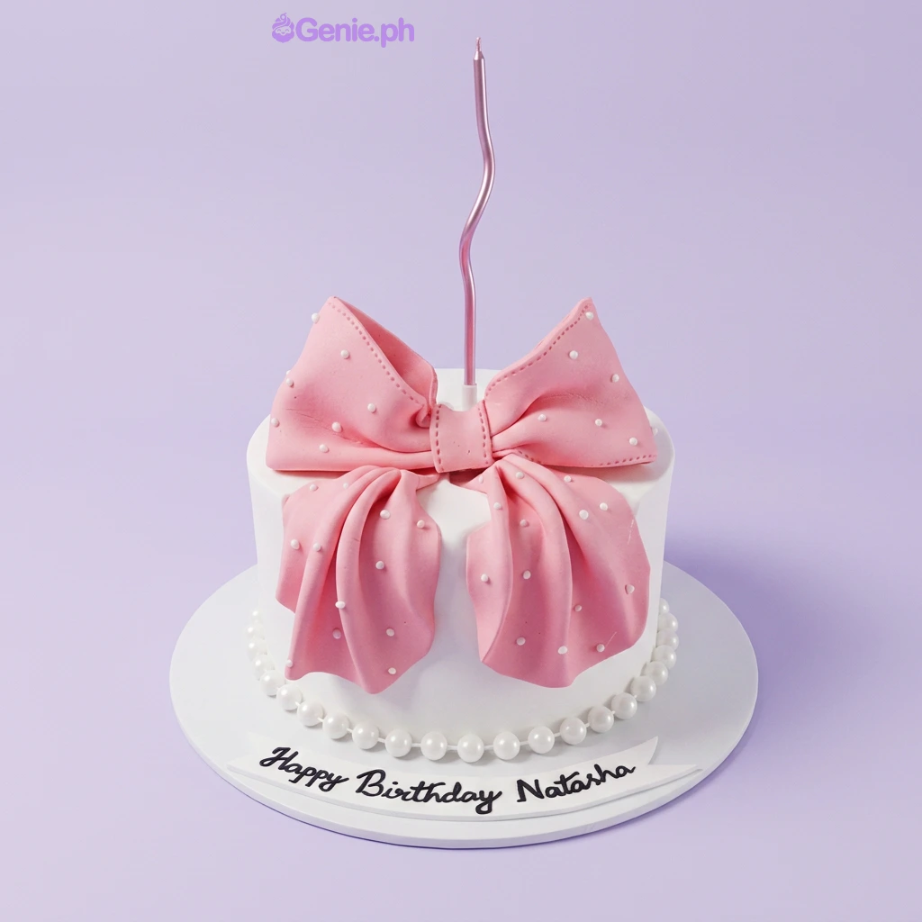 White 1-tier fondant cake with a large pink fondant bow topper and a pink spiral candle