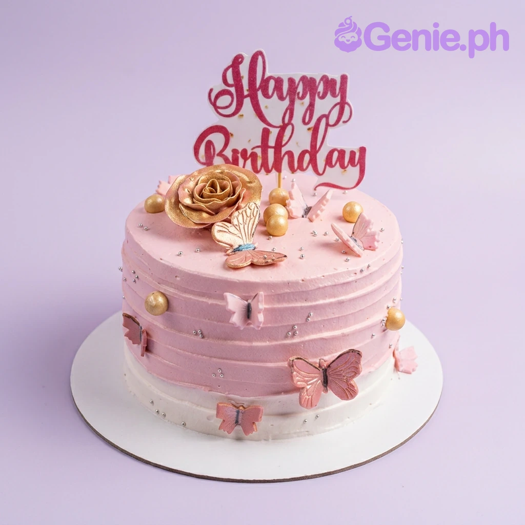 Pink Butterfly Floral Birthday Cake A pink cake, featuring a large rose gold rose, pink butterflies, gold spheres, and a Happy Birthday topper.