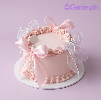 Pink Minimalist Light Pink Bow Cake Light pink 1-tier cake with soft icing, a large sheer organza bow, piped rosettes, and pearl accents