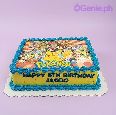 A blue and yellow rectangular Pokemon cake, with a character scene print, blue icing borders, and side text.