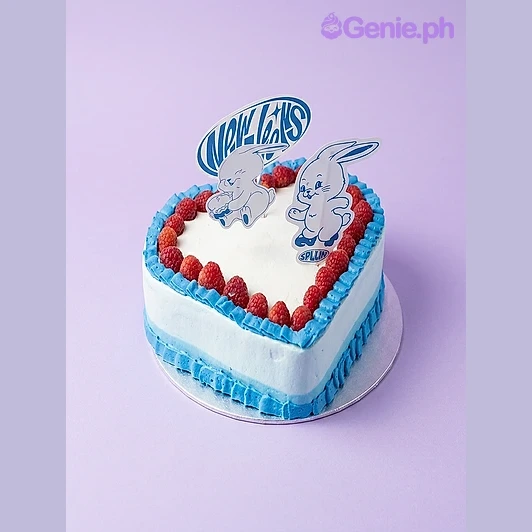 Rabbit Heart Sky Blue Birthday Cake Light blue heart-shaped cake with red strawberry border and cartoon rabbit and speech bubble printout toppers
