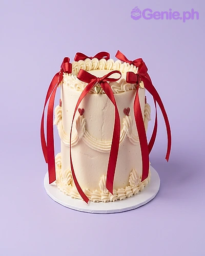 Red Ribbon White Heart Cake White 1-tier cake with red satin ribbons and small red fondant hearts