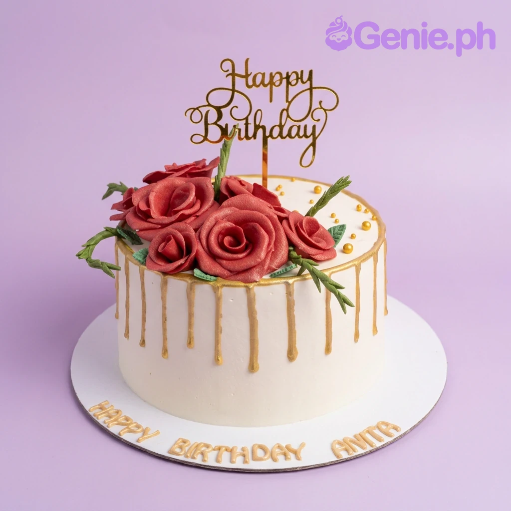 Red Rose White Drip Birthday Cake A white 1-tier cake with red gumpaste roses, a gold 'Happy Birthday' topper, gold drip, green leaves, and gold beads.