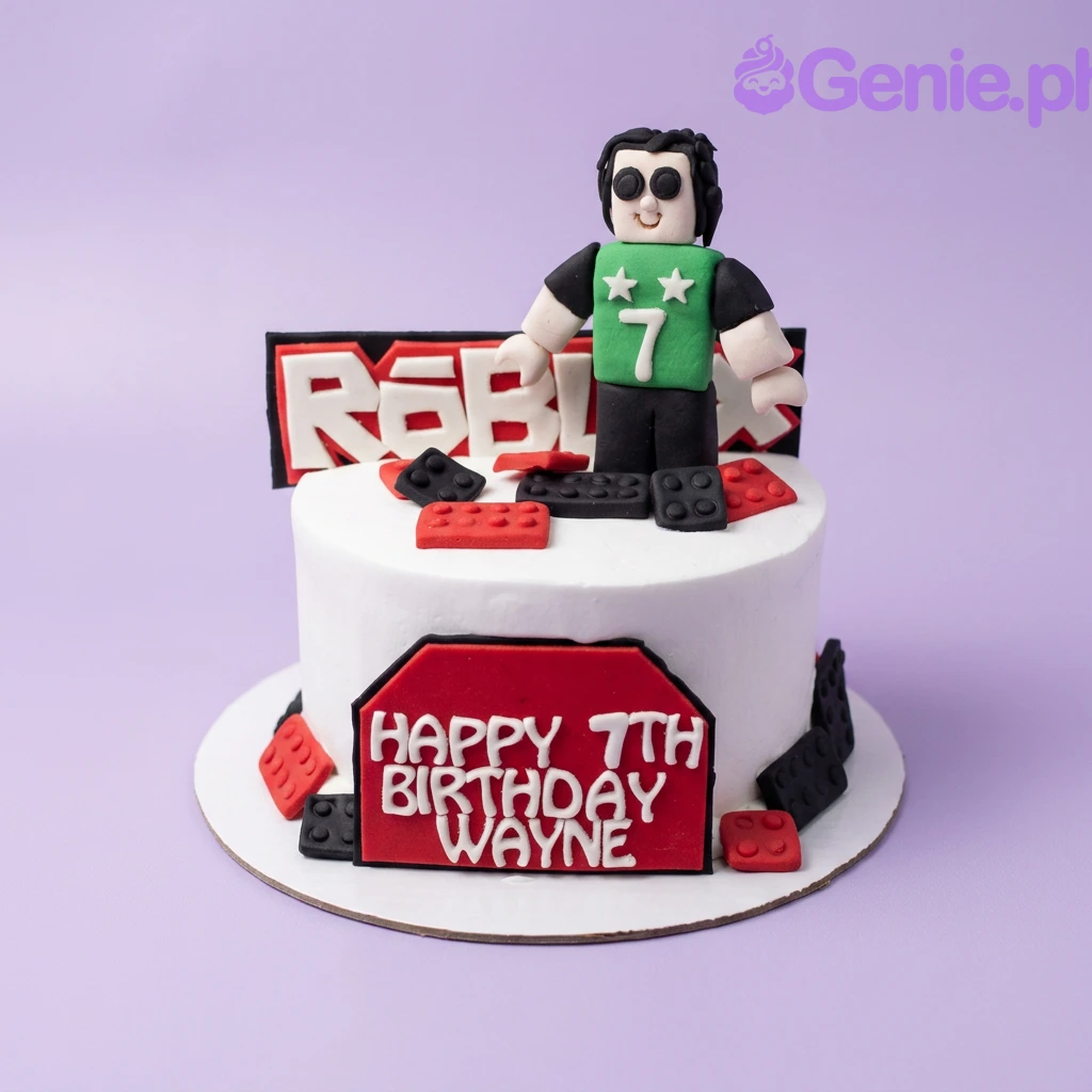 Roblox-Inspired White Birthday Cake A white fondant 1-tier cake themed Roblox, featuring a 3D Roblox character topper and red and black building blocks.